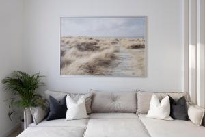 a living room with a couch and a painting on the wall at Luxurious & Spacious Central Residence with Balcony in Budapest