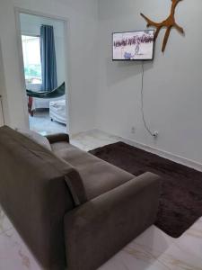 a brown couch sitting in a living room at Joia Centro Manaus - Apartamento in Manaus