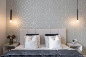 a bedroom with a white bed with two night stands at Luxurious & Spacious Central Residence with Balcony in Budapest