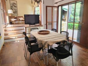 ein Esszimmer mit einem Tisch, Stühlen und einem TV in der Unterkunft Casa Caldes de Malavella, 3 dormitorios, 6 personas - ES-209-74 in Caldes de Malavella