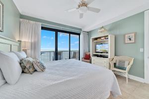a bedroom with a white bed with a view of the ocean at Grand Pointe Unit 303 in Orange Beach +37 photos