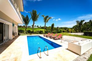 a swimming pool in the backyard of a house at Luxury Private Villas with Pool, Private Beach, BBQ in Punta Cana