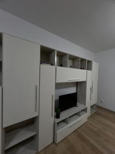 sala de estar con TV y pared blanca en Apartament Bragadiru complex rezidențial en Bragadiru