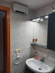 y baño con lavabo y espejo. en Alcossebre RESIDENCIAL ALANDALUS 5002 en Alcossebre