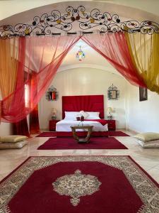 a bedroom with a large bed with a red canopy at Paradise house in Marrakesh