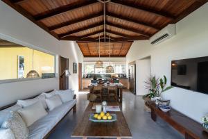 a living room with a couch and a table at Orixás Residence in Morro de São Paulo