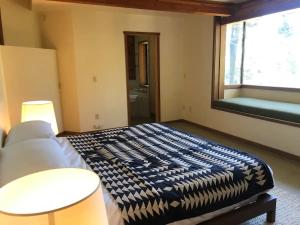 a bedroom with a bed and a large window at The Fireside Inn in Idyllwild