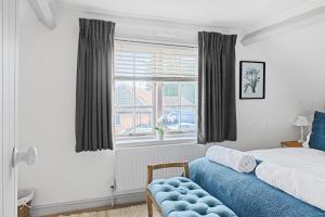 a bedroom with a bed and a window at Beautiful 2 Bedroom Cottage in Oxton in Oxton