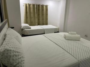 two beds in a room with two mattresses at Plataview Apartahotel apt 4A in Monte Plata