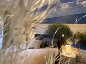 a bedroom with a bed with pillows and a window at Beach II Appartement in Bad Salzuflen