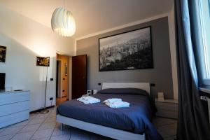 a bedroom with a bed with two towels on it at Dimora Lucchese in Lucca