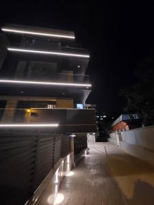 a row of lights on a building at night at Luxury Apartment in Bucharest