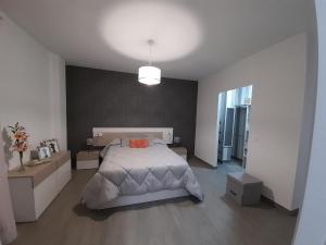 a bedroom with a large bed and a large window at Puerta de la Bética in Mengibar