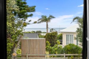 a view of the ocean from a house at The Summer Pad - Omaha Holiday Home in Warkworth