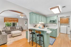 een open keuken en een woonkamer met groene kasten bij Secluded Paradise in San Augustine