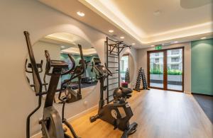 a gym with treadmills and ellipticals in a room at Mountains & SPA Apartament Zakopiański in Zakopane