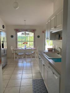 a kitchen and dining room with a table and chairs at Marco Island Retreat- close to beach ! in Marco Island