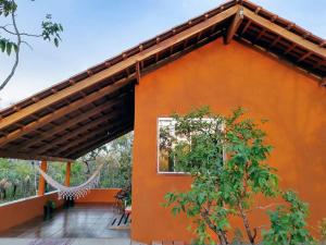 an orange building with a basketball hoop on it at Chalé toca do lobo in Sao Jorge