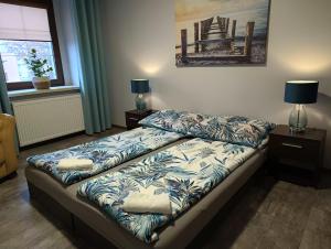 a bedroom with a bed with a bedspread and pillows at Przystanek Rozkochów in Rozkochów