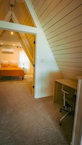 a bedroom with an orange bed in a attic at NJ Lakefront A-Frame, Millville, NJ - 2 bedroom Cabin Home in Millville