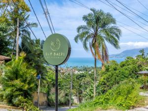 a sign for the ecg bart station with the ocean in the background at Eco Baepi Residence in Ilhabela