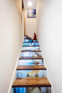 a stairway with a painting on the wall at Airstaybnb in Manchester