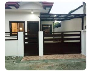 a stable with two doors and a fence at Kame House in Bacoor +2 photos