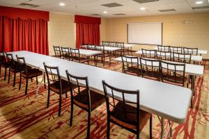 a conference room with tables and chairs and a whiteboard at Holiday Inn Express and Suites Hazard, an IHG Hotel in Hazard