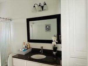 a bathroom with a sink and a mirror at Feel Home at Frisco in Frisco +51 photos