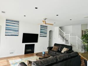 a living room with a couch and a fireplace at Feel Home at Frisco in Frisco