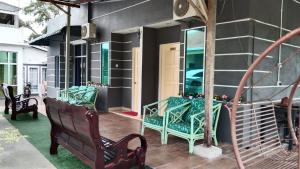 a porch with two benches and a staircase at PD ROOM STAY in Port Dickson