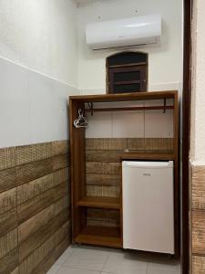 a small refrigerator in a room with a wall at Pousada Sitio Araça in São Miguel dos Milagres