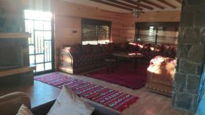 a living room with a couch and a table and chairs at Chez karim in Ifrane