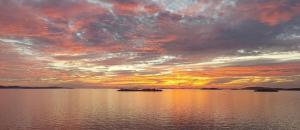 a sunset over a large body of water at Apartment Marietta in Tribunj
