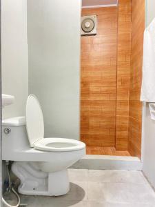 a bathroom with a toilet and a shower at Lime Lite Manila Hostel in Manila