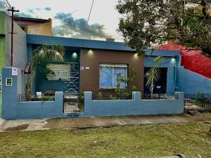 ein blaues Haus mit einem Zaun davor in der Unterkunft Casona in Laferrere