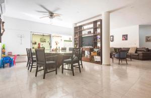 a dining room and living room with a table and chairs at Private Room Puerto Morelos in Puerto Morelos