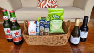 a basket filled with bottles of wine and snacks at Healing Garden Retreat - Ubud in Gold Coast