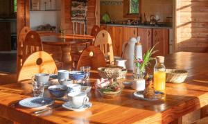 a wooden table with food on it in a kitchen at Hostal Zapato Amarillo in Puerto Octay