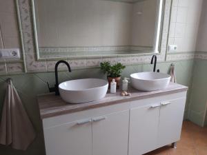 a bathroom with two sinks and a mirror at Casa La Romana in Aracena +45 photos