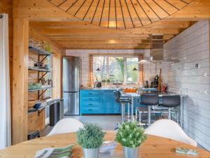 eine Küche mit blauen Schränken und einer Holzdecke in der Unterkunft Huize Tessel in Slenaken