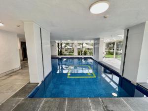a large swimming pool with a blue tile floor at Seacrest, Surfers Beach Front 15A in Gold Coast