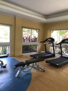 a gym with several exercise bikes and windows at SAN REMO OASIS 2BR COMFORT 30sqm in Cebu City