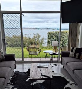 a living room with a view of the water at ON THE WATERS EDGE in Port Lincoln