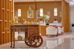 a wooden cart in the middle of a room at Crowne Plaza Muscat OCEC, an IHG Hotel in Muscat