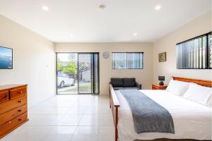 a bedroom with a bed and a desk and a chair at 14A Grafton St - Pet friendly air con studio for a couples retreat in Nelson Bay