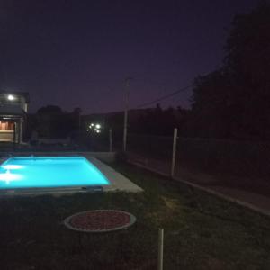 a swimming pool at night with a fence at Mecohue in Villa Giardino