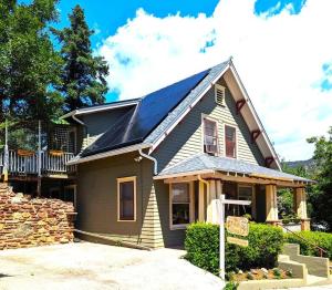 a house with solar panels on top of it at Manitou Springs White Yarrow Inn House in Manitou Springs