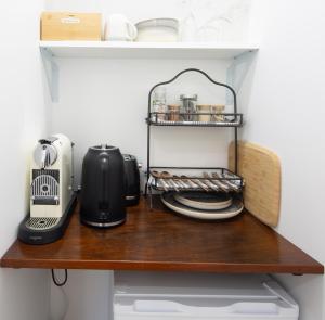 a shelf in a kitchen with a appliance on it at Seymour Sleeps in Nelson