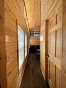 a hallway in a wooden cabin with a door at 93 Star Gazing Tiny Home Sleeps 8 in Valle